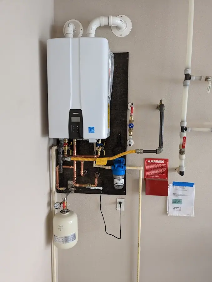 Professional plumber installing copper piping in a Waimalu home